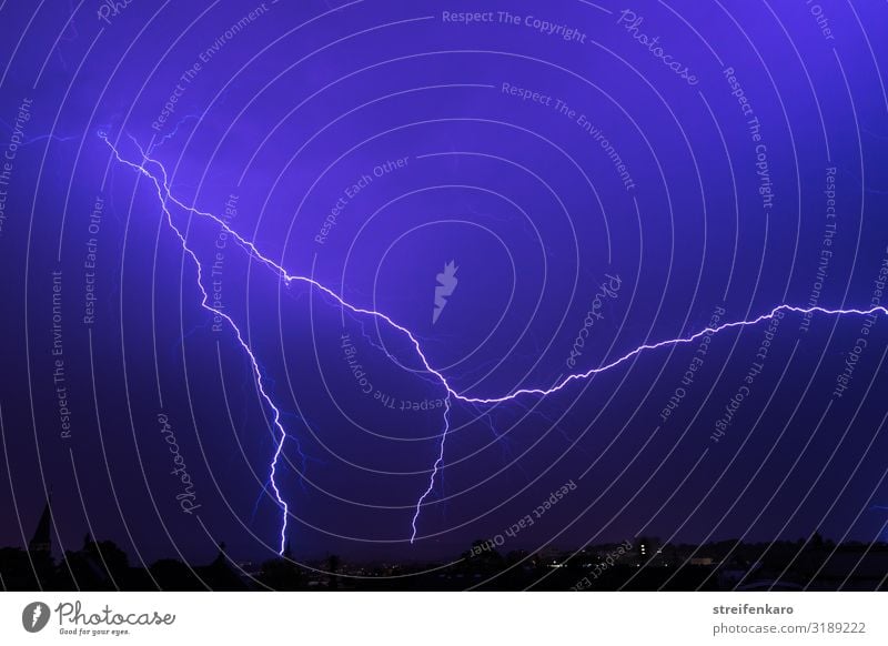 Bright flash in the dark blue night sky Environment Nature Elements Sky Storm clouds Thunder and lightning Lightning Aachen Town Downtown