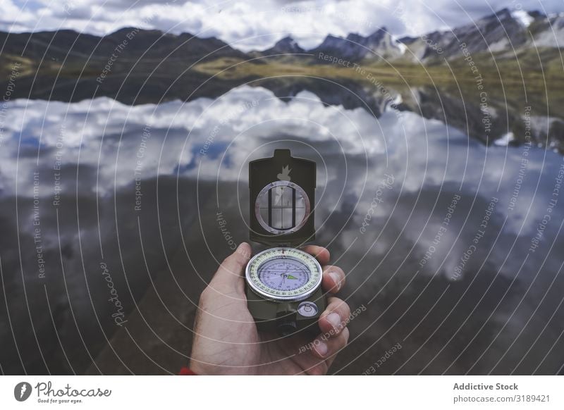 Crop hand with compass near lake Hand Compass (drafting) Lake Tourist embalse de casares Léon Spain Mountain Valley tranquil Trip Adventure Vacation & Travel