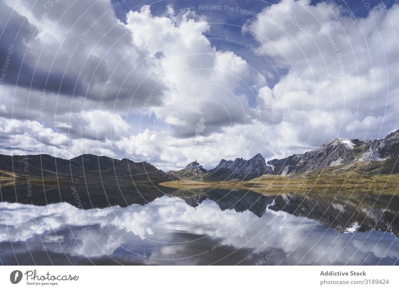 Cloudy sky over calm lake and mountains Lake Mountain Clouds Sky Calm embalse del casares Spain Léon Reflection Landscape Nature Deserted Basin Pond Weather