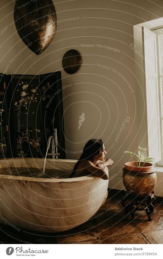 Melancholic Woman sitting and washing in bath Bathroom Bathtub Clean Washing Towel Relaxation Comfortable Tourism Trip Vacation & Travel Beautiful Home Resting