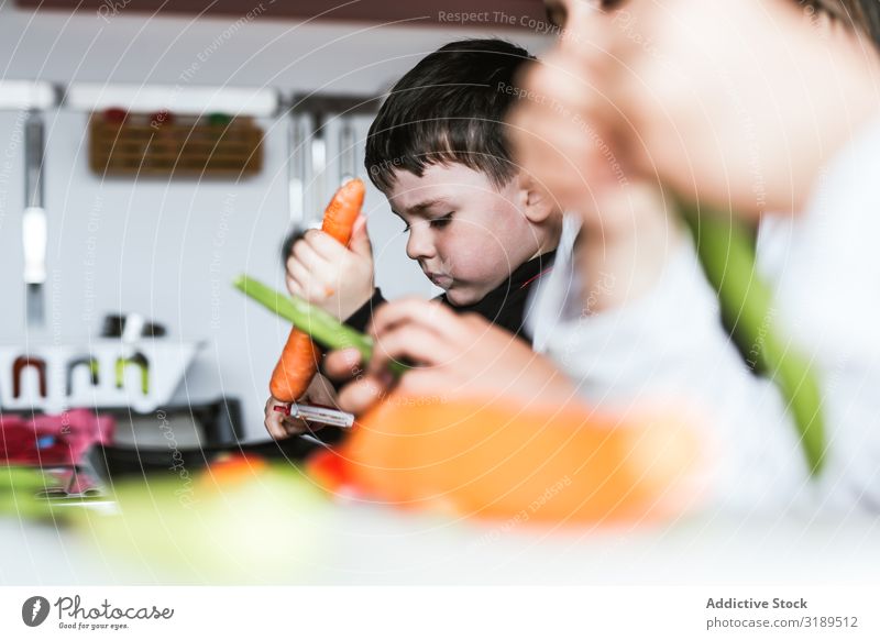 Siblings preparing vegetables for salad siblings Vegetable Kitchen Cooking Peeling cutting Salad Home Girl Boy (child) Vegan diet Healthy Fresh Child Sister