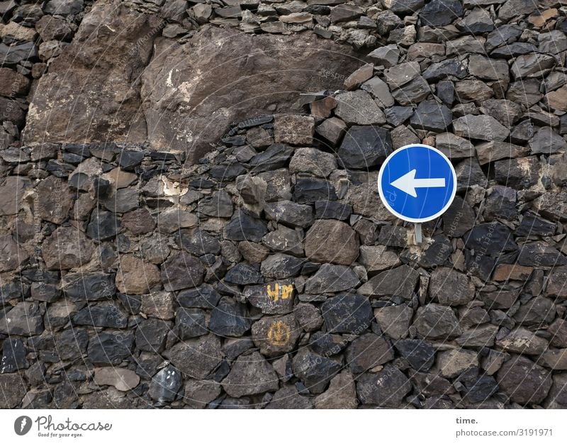 Proposed direction Stone Wall (barrier) sign Road sign stones Dark Brown Blue Left Direction Orientation daylight Transport Arrangement Sign Arrow