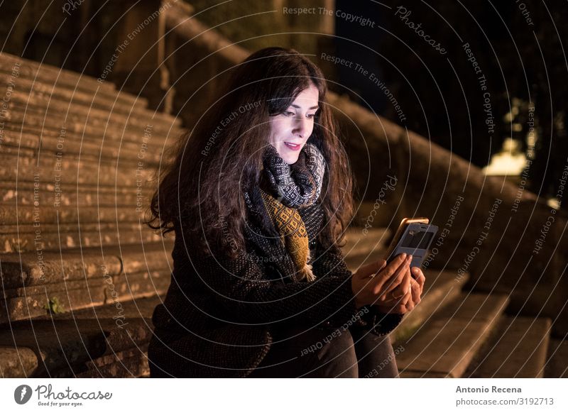 Sit woman on cathedral stairs looking smartphone Happy Telephone Technology Human being Woman Adults Autumn Architecture Smiling Europe Baeza spanish Caucasian