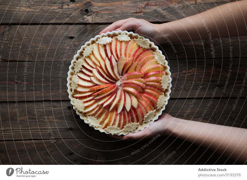 unrecognizable woman showing a tasty apple pie on a wooden table Pie Apple Fresh Wood Rustic Window Home-made Day Brown Confectionary Organic parchment Warmth