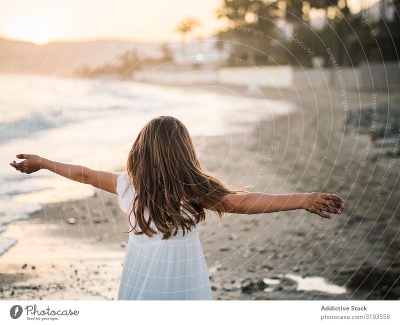 Excited girl running along beach in daylight Girl Running Beach Excitement Day having fun Playing Child Coast Cheerful seaside Delightful Sand Summer Infancy