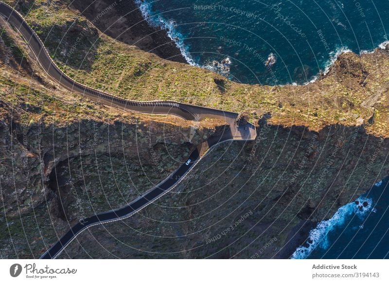 Curving road through desert landscape Street curving Desert Landscape drone view Empty Aircraft Winding Countries Green Tenerife Spain Sunbeam Light