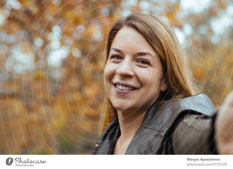 Young woman taking a selfie in the park in autumn Cellphone Camera Human being Feminine Youth (Young adults) Woman Adults Face 1 30 - 45 years Autumn Park