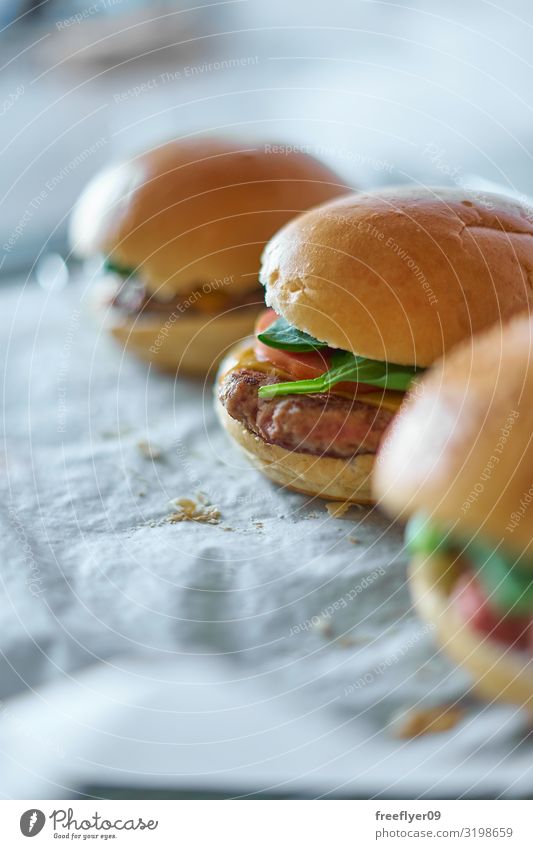 Homemade hamburguers on baking paper Meat Cheese Vegetable Bread Roll Nutrition Lunch Fast food Gastronomy Paper Piece of paper Fresh Delicious Natural