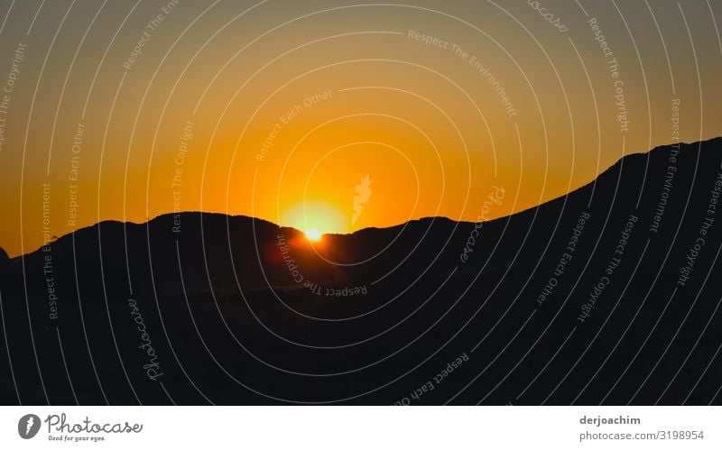 Night is coming. The sun is barely visible. It dives away under the dark sand dunes. Joy Relaxation Environment Summer Beautiful weather Desert Namibia Africa