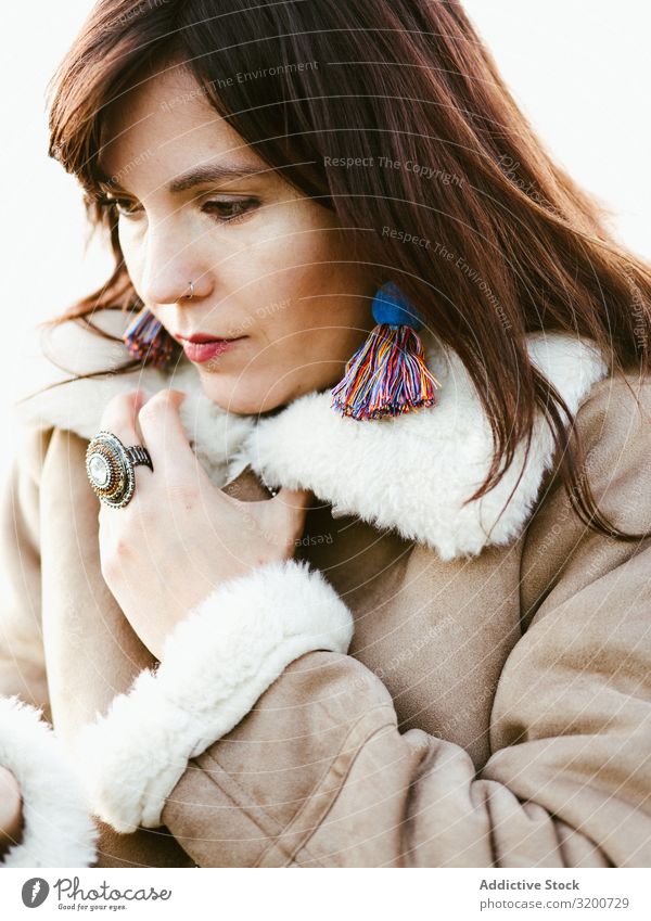 Portrait of thoughtful model with handmade earrings Portrait photograph Model Earring Self-made Considerate Woman Beautiful Brunette Thread Hip & trendy