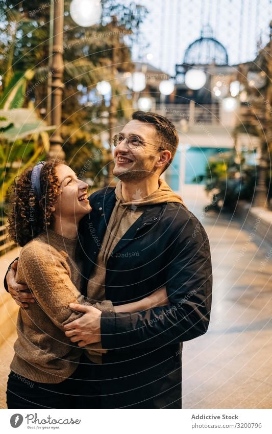 Happy couple hugging in pavilion Couple Embrace Date Pavilion looking at each other Youth (Young adults) City Love romantic Man Woman Together girlfriend