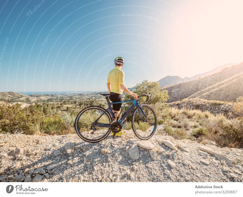 man resting and enjoying the views while riding a bicycle on a mountain road Leisure and hobbies Athlete Sports Ride Bicycle Racing sports Man Motorcycling