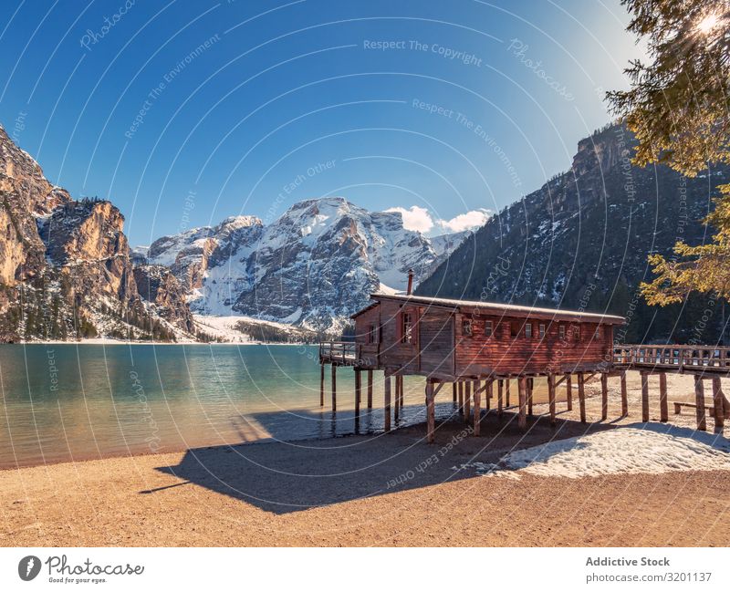 Wooden house on stilts on serene lake Pile-dwelling Serene seascape Break water Nature Ocean Rock Landscape Coast Water Beach Vacation & Travel Tourism Natural