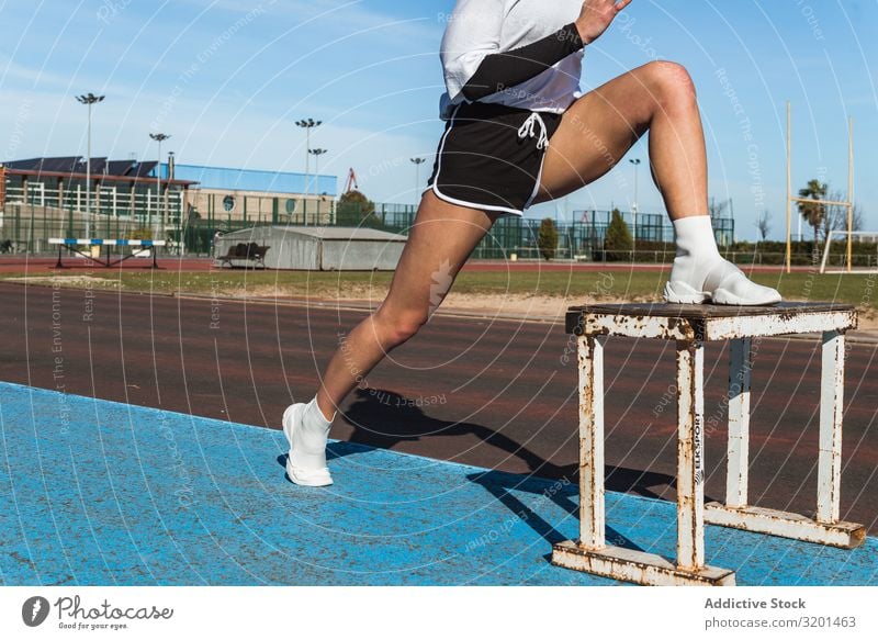 Female athlete stretching on stool on stadium Woman Stretching Stadium lengthen Sports Track Youth (Young adults) Sportswear Sky Blue Competition Athlete