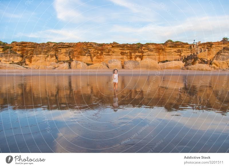 Little girl walking on water of beach seashore Girl Child Ocean Beach Summer Small Human being Curly hair Barefoot Beautiful Action Walking Vacation & Travel