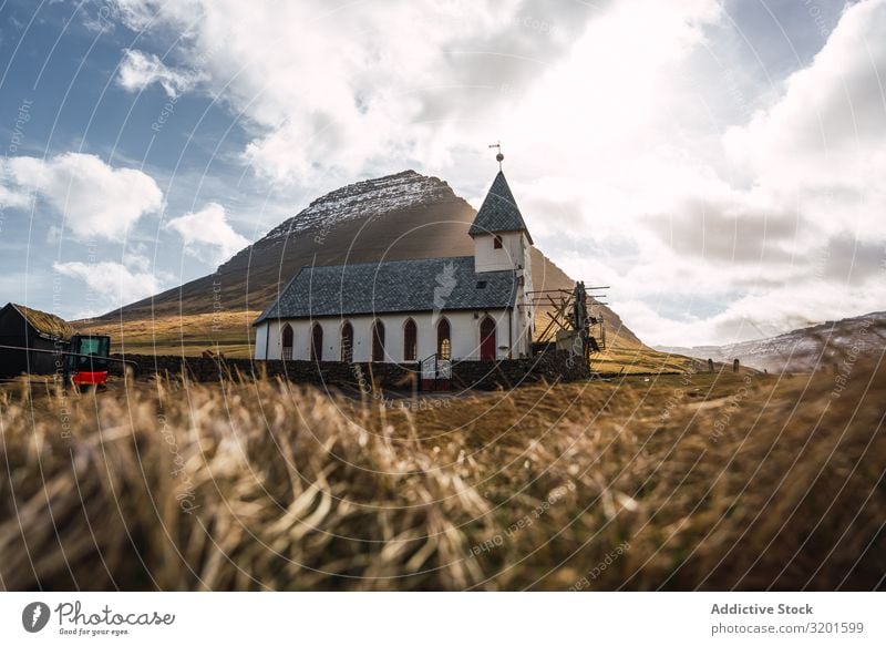 Small church standing in dry valley near high hill in Faroe island Church Hill Valley North Landscape Nature Vacation & Travel Trip Tourist Dry Beautiful Rural