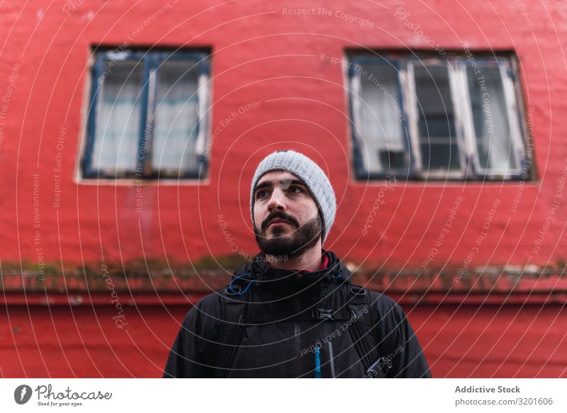 bearded man looking away while standing in front of red building in faroe island Model Attractive Man handsome Beautiful Calm Lifestyle suave