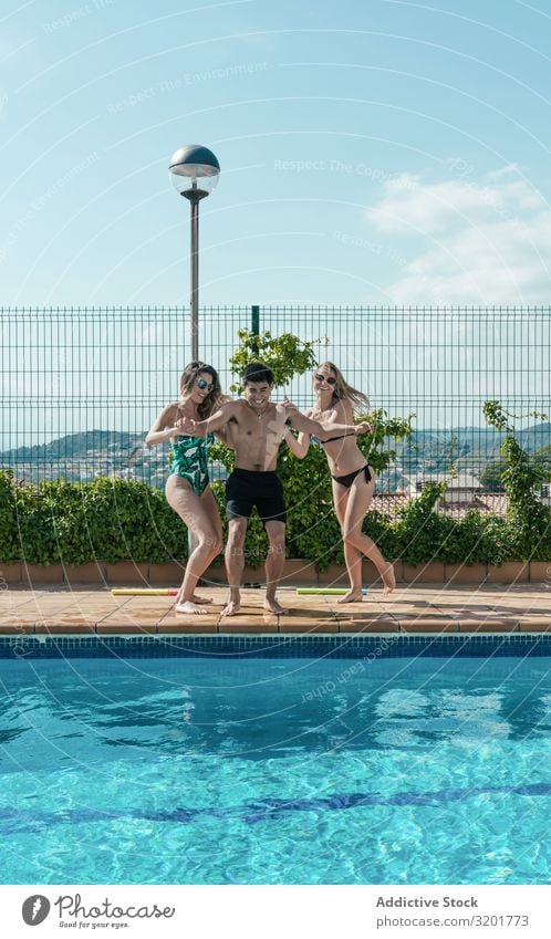 Friends playing with water pistols in the pool Attractive Background picture Beautiful Bikini Caucasian Cheerful Woman Festival Friendship Joy Girl gun Handgun