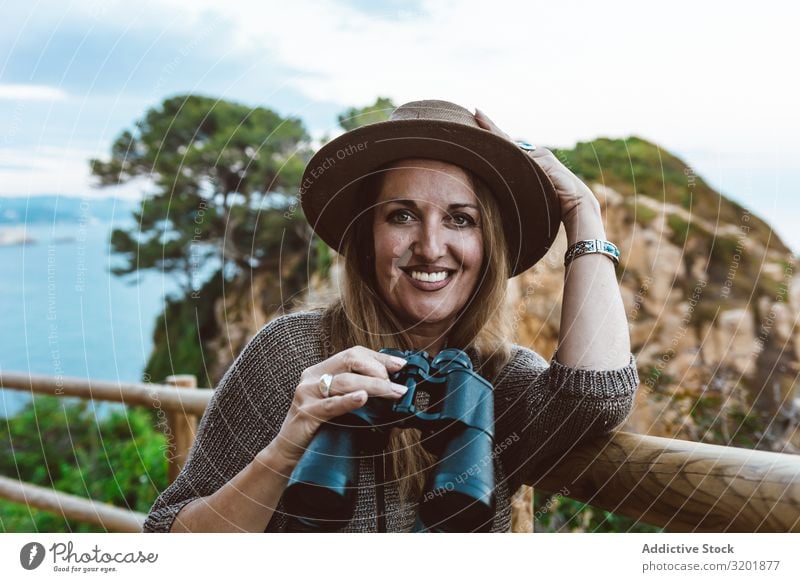 Woman with binocular on coastal walkway seascape Coast explore Vantage point Vacation & Travel Ocean Nature Tourism Adults Far-off places Observe marine