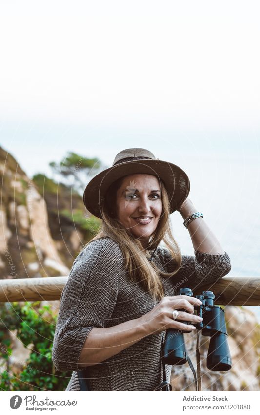 Woman with binocular on coastal walkway seascape Coast explore Vantage point Vacation & Travel Ocean Nature Tourism Adults Far-off places Observe marine