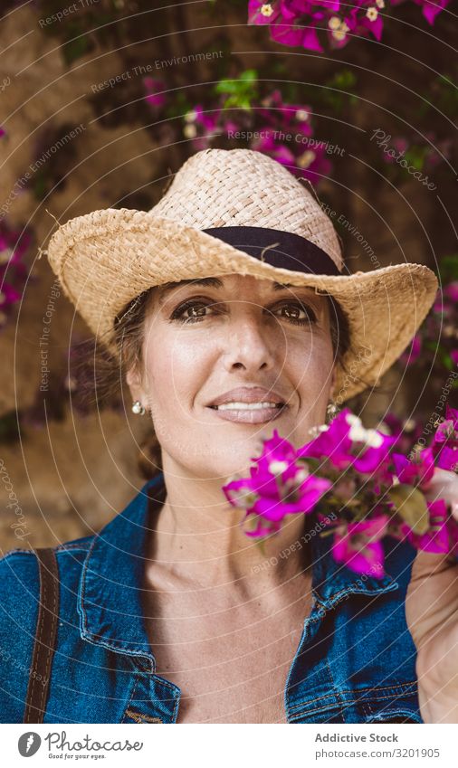 Woman standing near a wall with flower shrubs Beautiful Lifestyle Human being Street Summer Tourist Town traveler Trip Vacation & Travel Exterior shot Europe