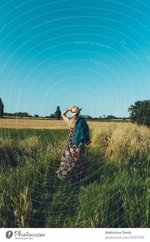 Female farmer with hat looking at her wheat crop. Woman Beautiful Dress Happy Lifestyle Human being Summer Tourist Vacation & Travel Trip Youth (Young adults)