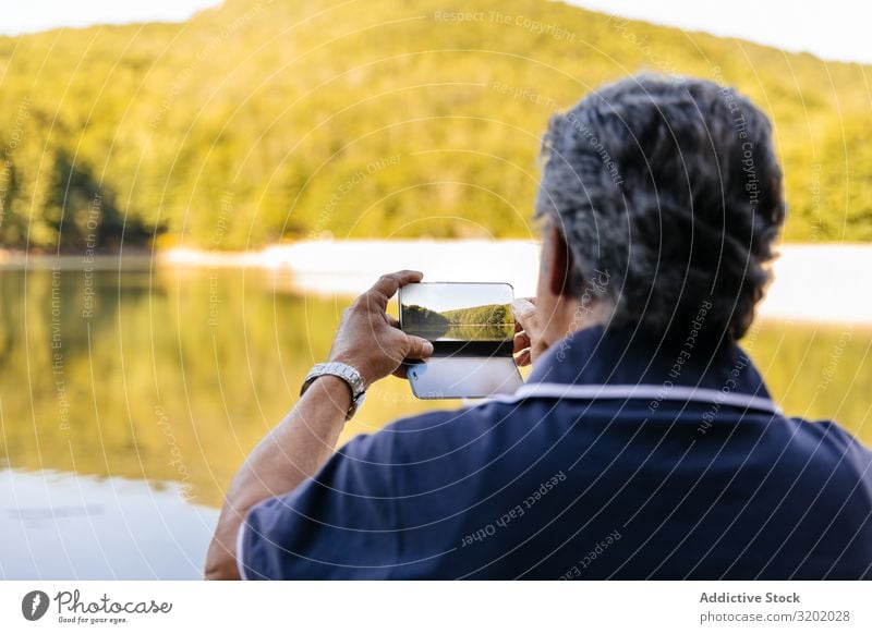 Man taking picture of landscape Senior citizen Mountain Hiking Nature Lifestyle trekking Healthy Landscape Lanes & trails Exterior shot retired Action Practice