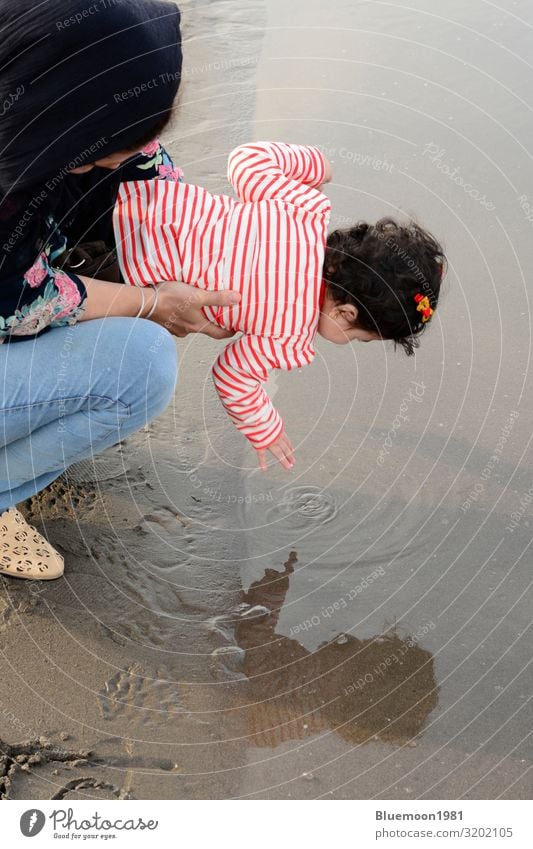 Mother and young child at beach playing with water Lifestyle Joy Beautiful Playing Vacation & Travel Beach Ocean Human being Baby Woman Adults Parents