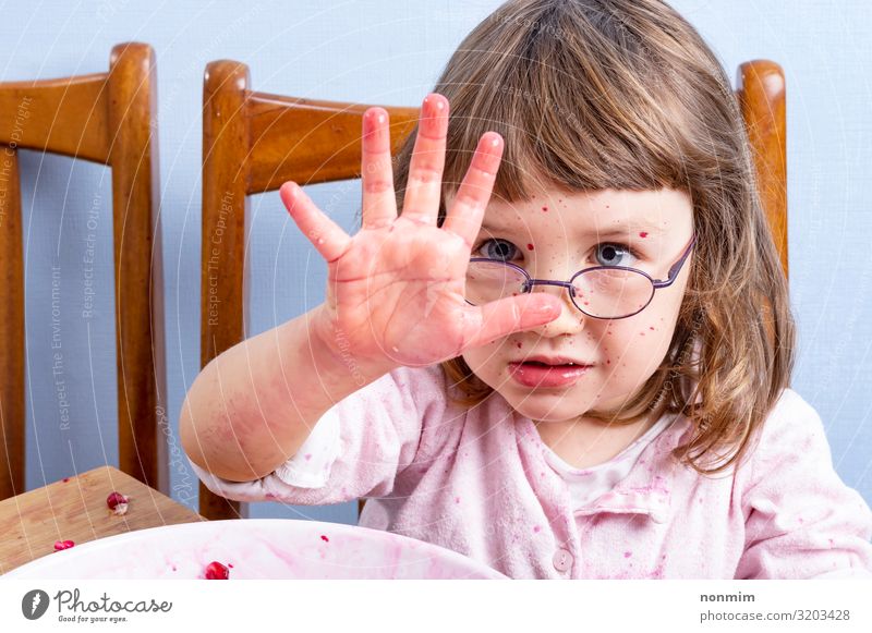 Girl squeezing pomegranate juice, making mess. Dirty hand Fruit Dessert Nutrition Vegetarian diet Diet Beverage Juice Lifestyle Exotic Joy Face Playing Child