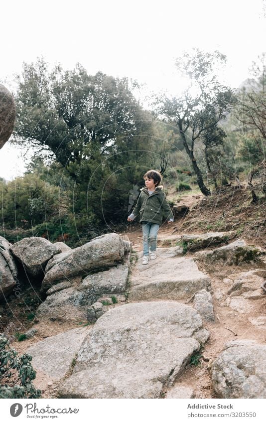 Boy walking on rocky hill Boy (child) Nature Hill To go for a walk Walking Rock Vacation & Travel Child Recklessness Landscape Downward Adventure Action Infancy