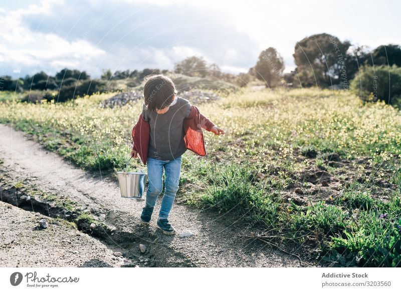 Kid with bucket walking on rural road Boy (child) Nature Landscape Street Bucket Summer Delightful Small Vacation & Travel Child Action Happy Infancy