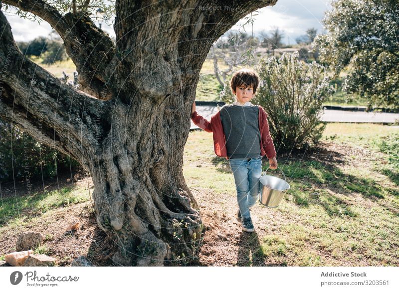 Kid with bucket walking on rural road Boy (child) Nature Landscape Street Bucket Summer Delightful Small Vacation & Travel Child Action Happy Infancy