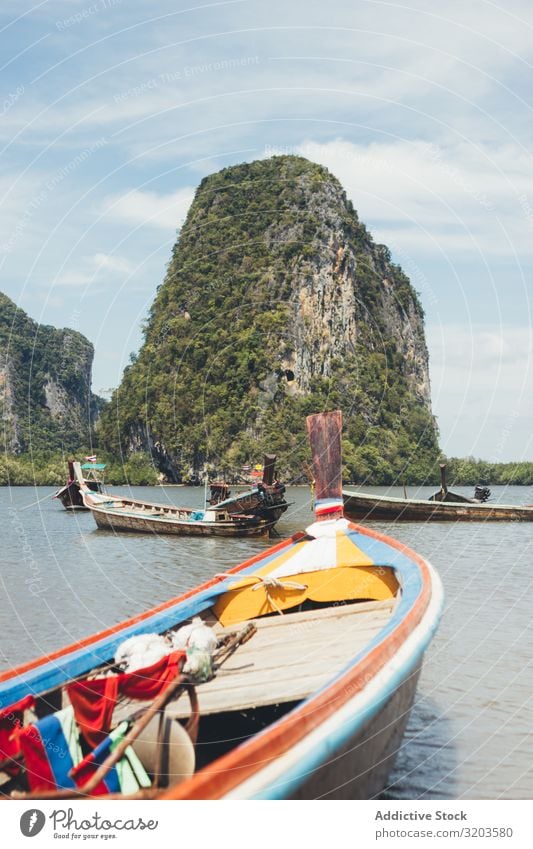 Traditional boats floating in tropical bay Bay Watercraft Tropical Lagoon Float in the water Thailand Landscape Green Rock Coast Beach seascape