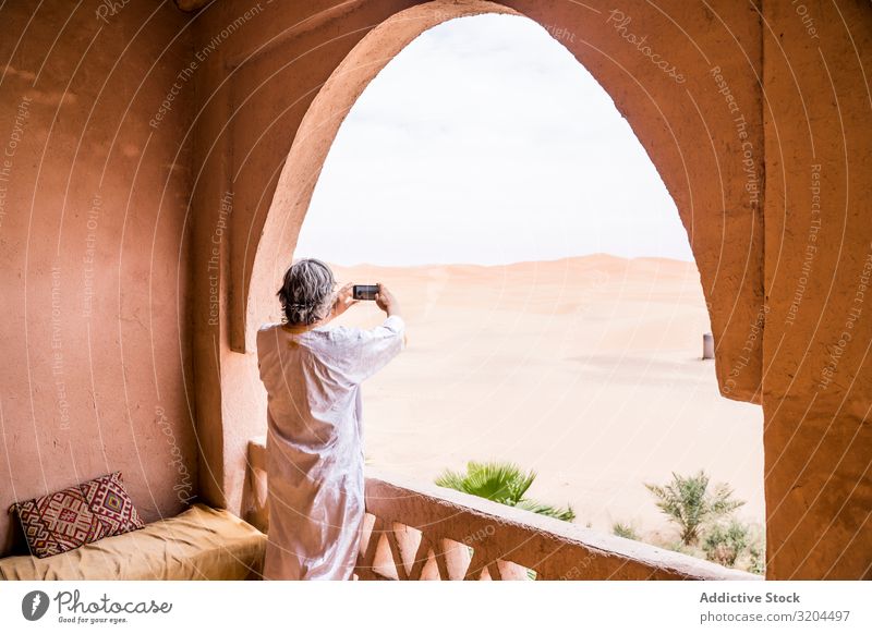 Man taking photo of desert from balcony Desert Balcony Morocco Vacation & Travel Vantage point PDA Landscape Heat Exotic oriental Tourism Nature Tourist Terrace