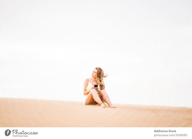 Happy woman using smartphone in desert Woman Desert Cheerful Communication Cellphone Technology Vacation & Travel Style Guest Morocco Joy Summer