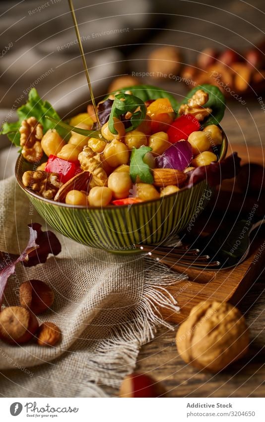 Bright vegetables with chickpeas in bowl and walnuts Chickpeas Walnut Nut Vegetable Healthy Food Organic Vegan diet appetizing Green Salad Raw Eating Meal Fresh