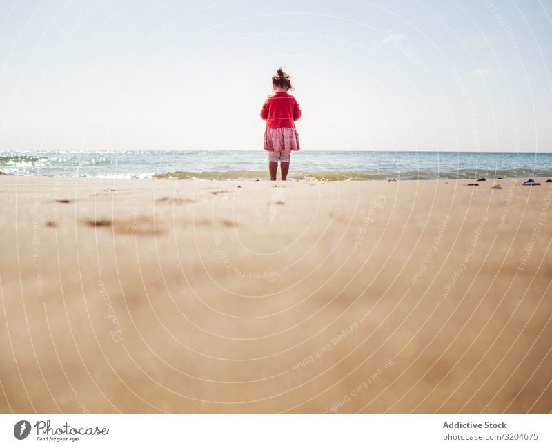 Girl walking on beach in sunny day Beach Walking Sunbeam Day Toddler Sand seaside Water Calm Coast Infancy Vacation & Travel Action Child enjoying Positive