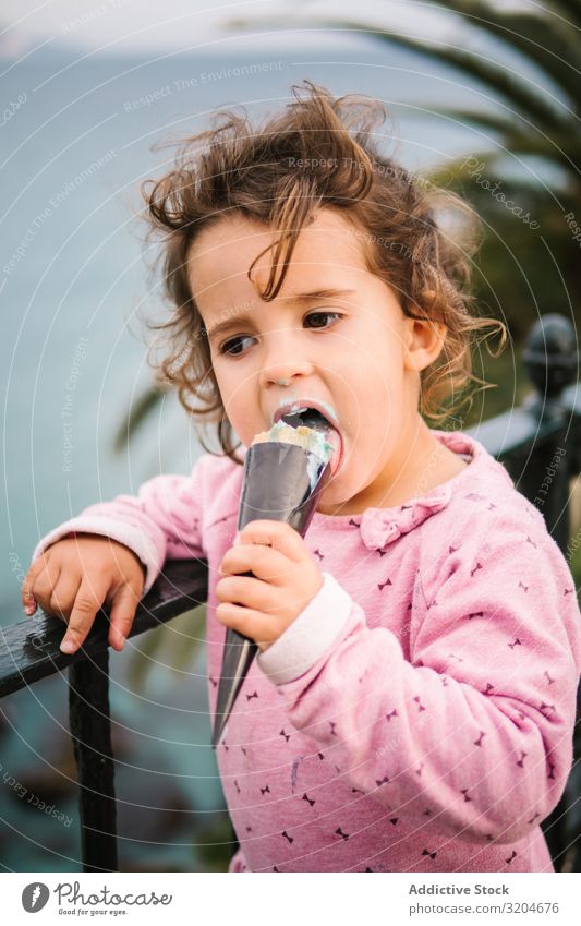 Adorable serious toddler girl with ice-cream Girl Toddler Ice cream Earnest Delightful Charming Pensive Eating Portrait photograph Infancy Child Innocent