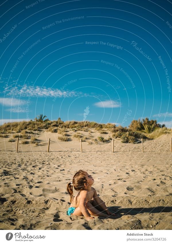 Girl playing on beach in sunny day Beach Playing Sunbeam Day Toddler Sand Delightful seaside Coast Infancy Serene Vacation & Travel Action Sunbathing Child