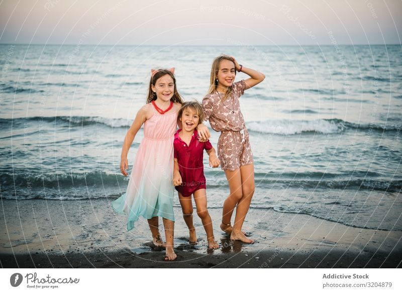 Kids playing in shallow water Child Beach Wave Family & Relations Summer Group Together sibling Happy Action Vacation & Travel Fresh Ocean Sister Brother