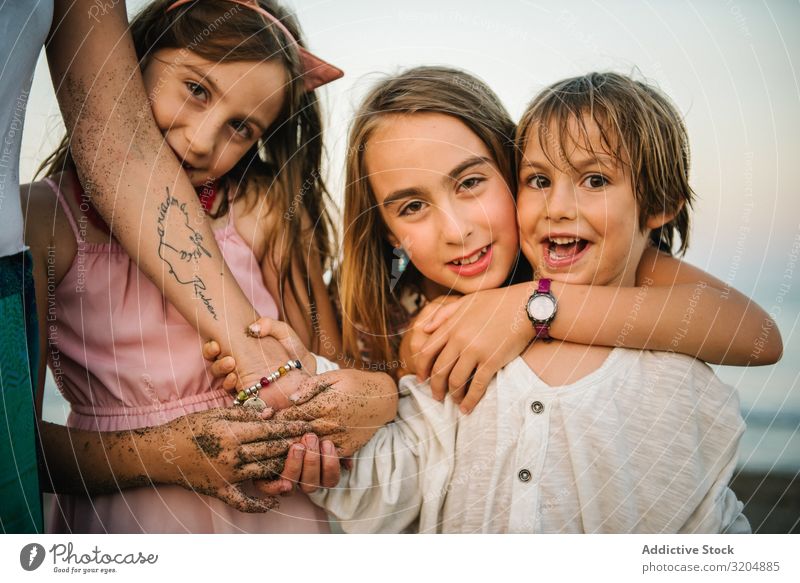 Anonymous woman with kids on seashore Woman Child Beach Love Family & Relations Laughter Happy sibling Group Mother Coast Together Vacation & Travel Small