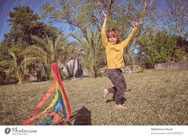 Boy launching kite on summer day Boy (child) Kite Sky Joy Infancy Playing Flying Landscape Child Small Human being Action Playful Easygoing Recklessness