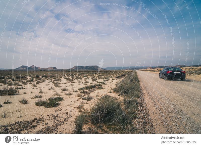 Car driving on empty road along desert Desert Amazing Landscape road trip Empty semi Street Vacation & Travel Nature Speed Asphalt Trip Adventure Freeway