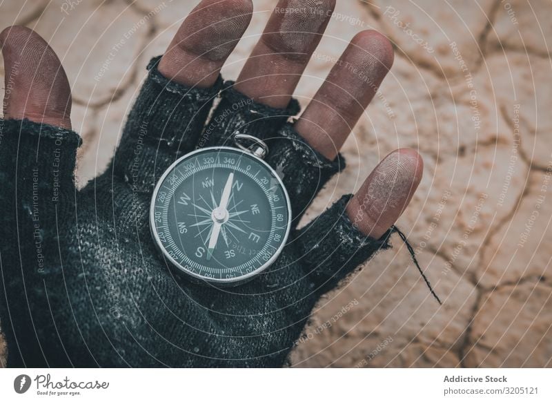 Compass in hand on dry desert area Compass (drafting) Direction Desert Equipment Orientation Sand Adventure Vacation & Travel exploration Geography Magnetic