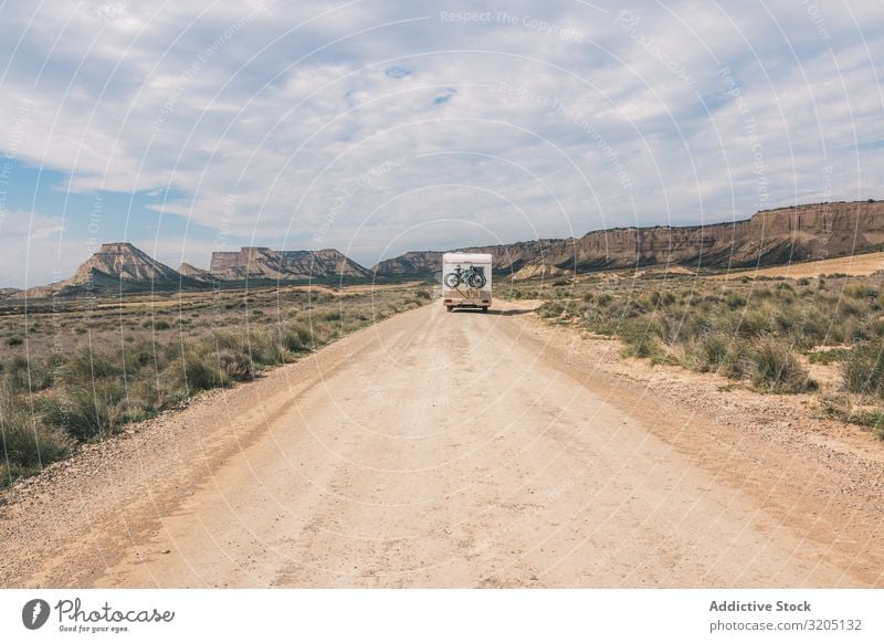 White trailer on empty road along desert Trailer Desert Amazing Empty Street Vacation & Travel Caravan Landscape Nature Speed Asphalt Trip semi Adventure