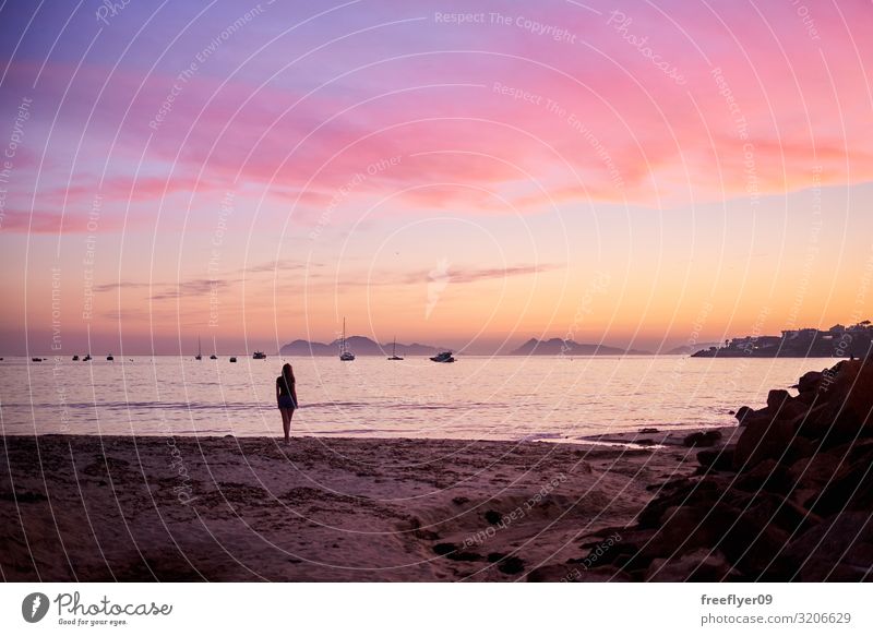 Young woman contemplating the sunrise from a beach Joy Beautiful Wellness Well-being Relaxation Leisure and hobbies Vacation & Travel Tourism Far-off places