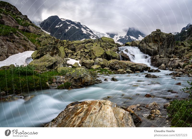 Glacier River high in the Swiss Alps Landscape Water Clouds Summer Climate change Snow Mountain Waterfall Hiking Moody Flow Brook Rock Vacation & Travel Cold