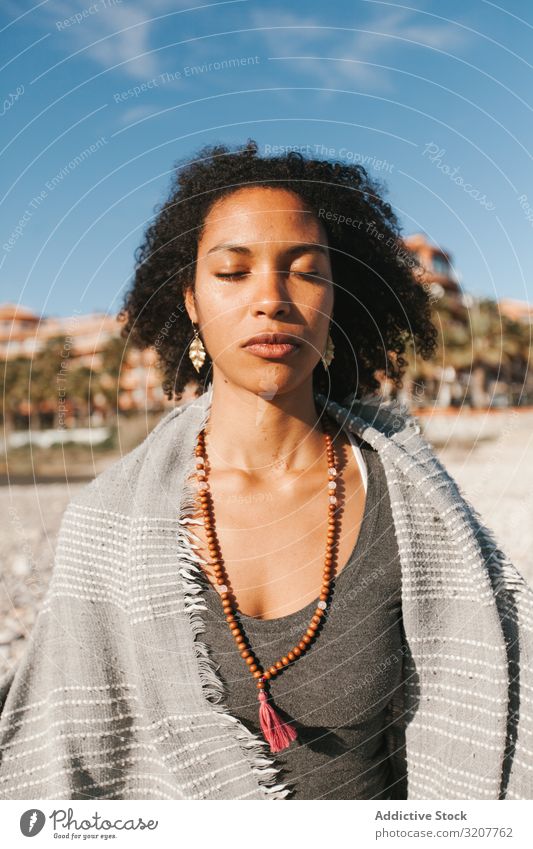 Sportive woman sitting on sandy beach in asana meditating practicing yoga position relaxation exercise beautiful fitness sport leisure female workout meditate