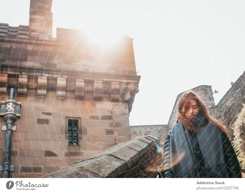 Stylish woman walking in aged medieval building travel old town scotland tourist street style explore architecture city tourism black trendy heritage exterior