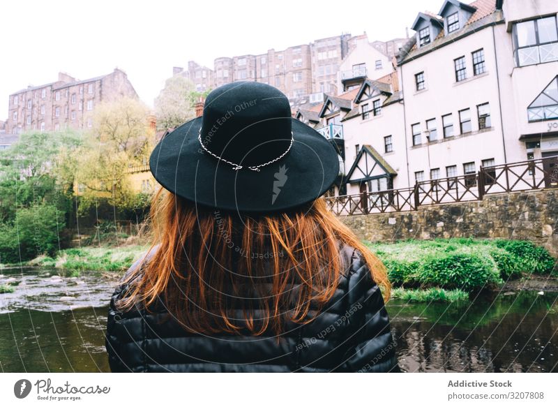 Woman contemplating city aged stone buildings woman town river scotland medieval travel bridge scenic green bush tourism old destination landscape architecture